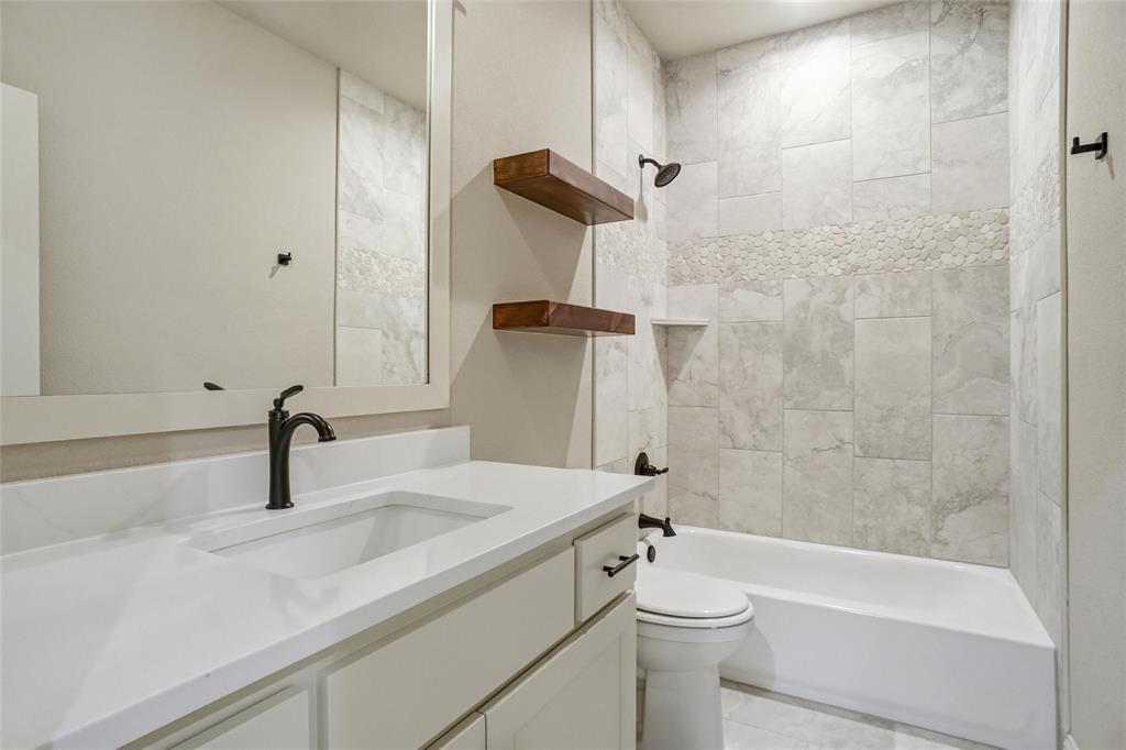 201 Legacy Boulevard Weatherford, TX 76085 - Photo 23 of 25 a bathroom with a sink a toilet and shower