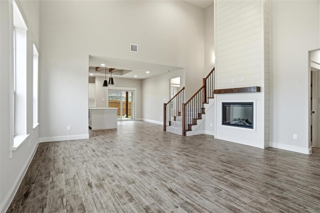 201 Legacy Boulevard Weatherford, TX 76085 - Photo 3 of 25 a view of empty room with wooden floor and fireplace