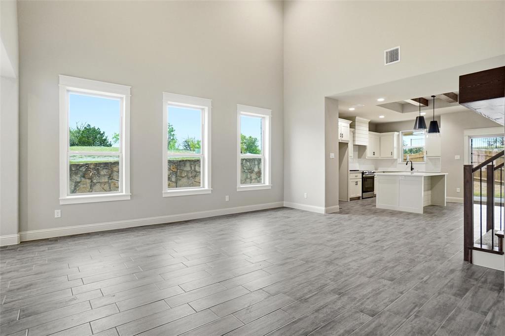 201 Legacy Boulevard Weatherford, TX 76085 - Photo 4 of 25 an empty room with wooden floor and windows