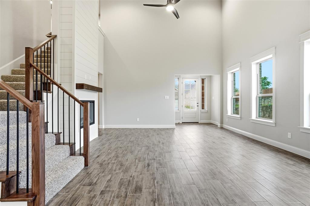 201 Legacy Boulevard Weatherford, TX 76085 - Photo 5 of 25 a view of an empty room with wooden floor and a window