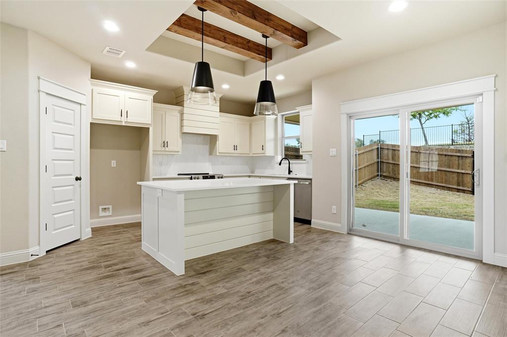 201 Legacy Boulevard Weatherford, TX 76085 - Photo 6 of 25 a kitchen with stainless steel appliances a stove and a refrigerator