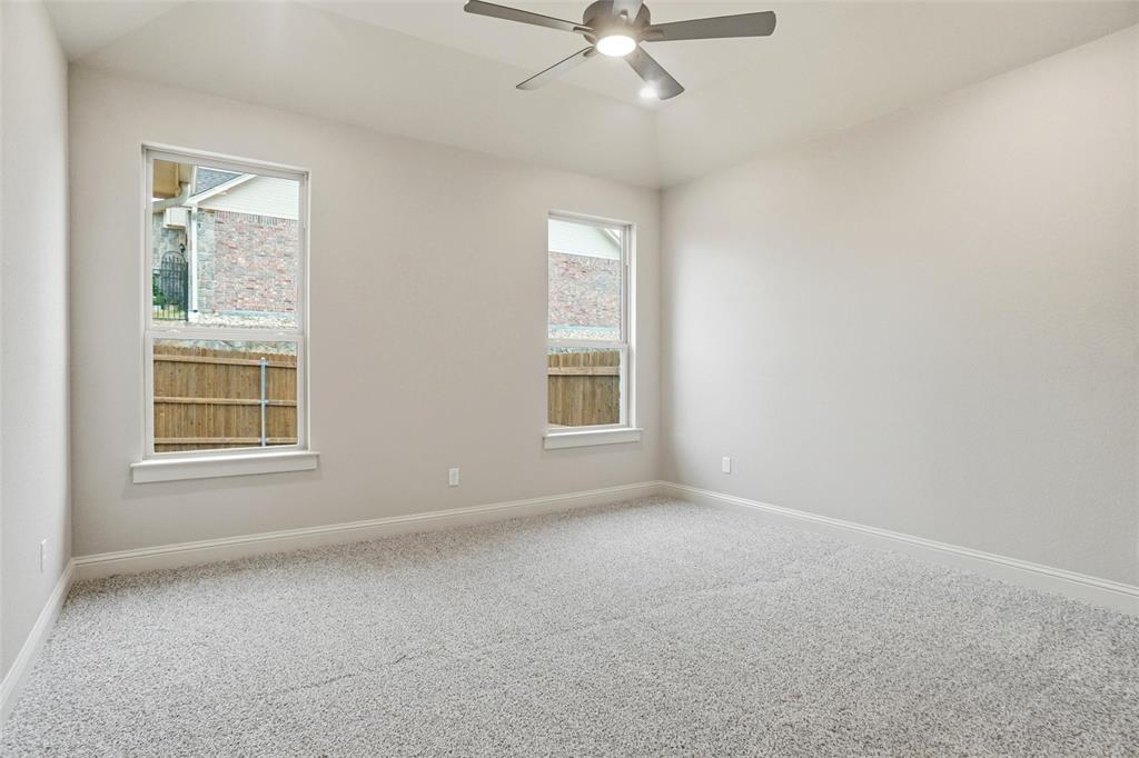 201 Legacy Boulevard Weatherford, TX 76085 - Photo 10 of 25 an empty room with a window and a fan