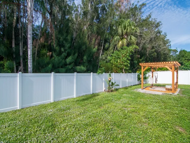 a white house that has a tree in front of it