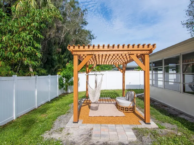 a view of a patio with a table chairs and a backyard