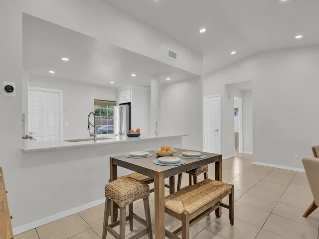 a kitchen with a dining table and chairs