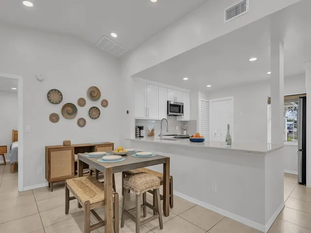 a kitchen with stainless steel appliances kitchen island granite countertop a sink and a stove