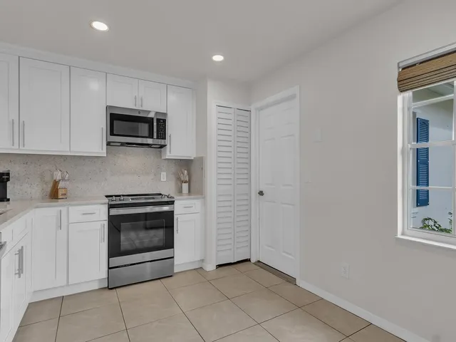 a kitchen with stainless steel appliances granite countertop a stove and a sink