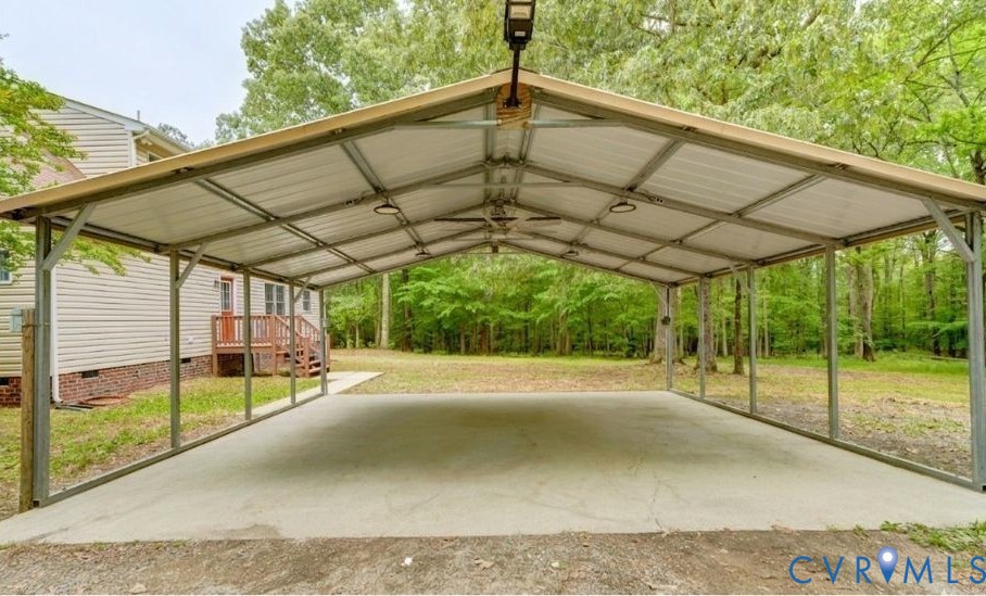 3820 Mt Pleasant Road Providence Forge, VA 23140 - Photo 39 of 40 a view of a backyard with table and chairs under an umbrella