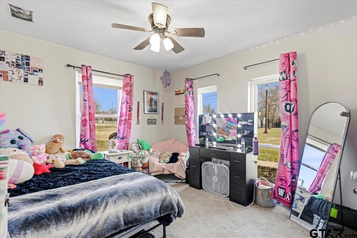 18919 State Highway 64 Canton, TX 75103 - Photo 14 of 42 a bedroom with bed and a chandelier