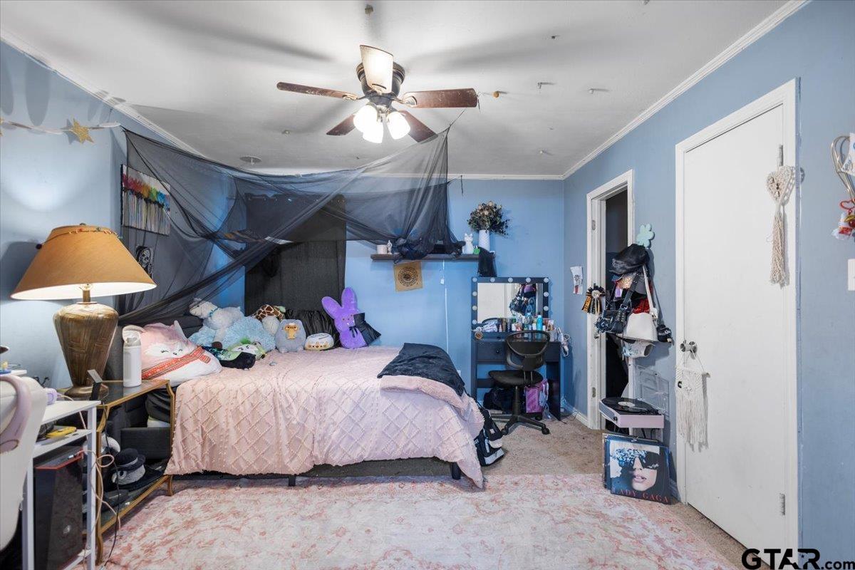 18919 State Highway 64 Canton, TX 75103 - Photo 17 of 42 a bedroom with bed and a chandelier