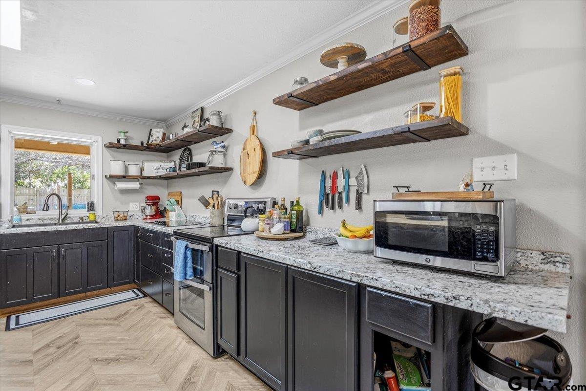 18919 State Highway 64 Canton, TX 75103 - Photo 24 of 42 a kitchen with stainless steel appliances granite countertop a sink and stove top oven