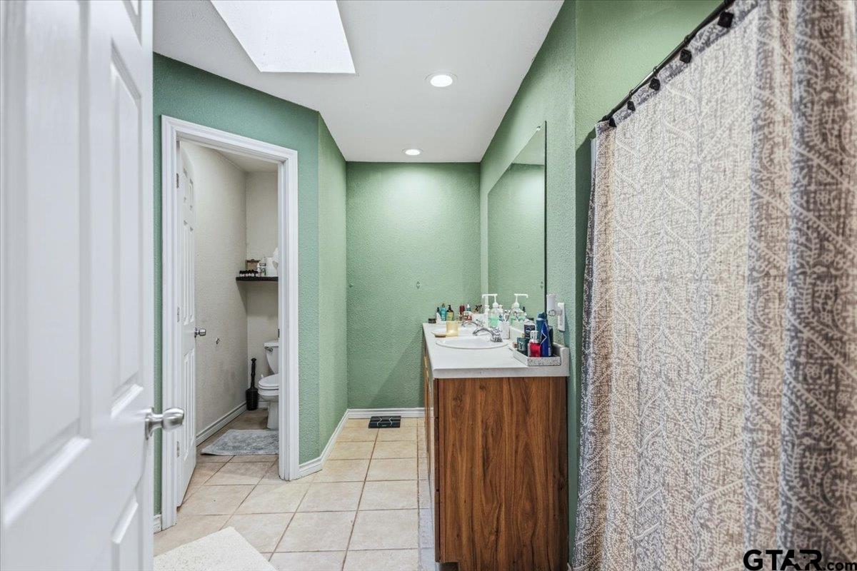 18919 State Highway 64 Canton, TX 75103 - Photo 28 of 42 a bathroom with a sink mirror and a shower