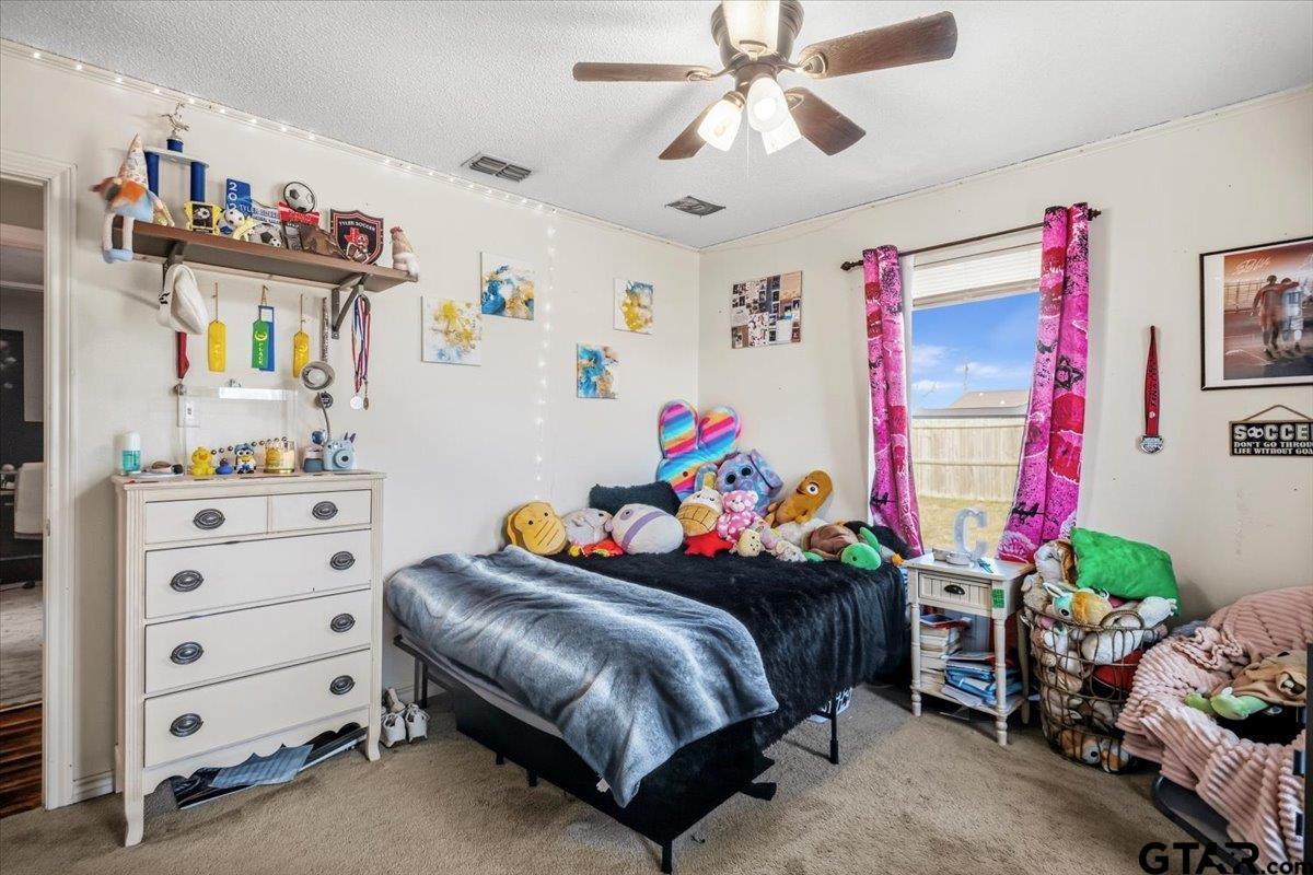 18919 State Highway 64 Canton, TX 75103 - Photo 8 of 42 a bedroom with a bed and a chandelier