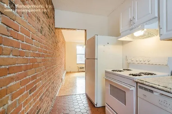 a kitchen with granite countertop white cabinets and white appliances
