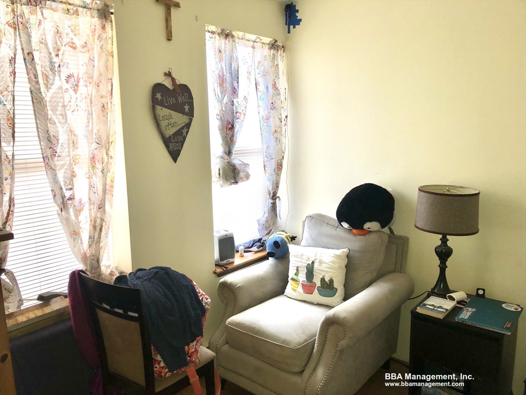 4 Cypress Road, Unit 406 Boston, MA 02135 - Photo 13 of 31 a living room with furniture and a window