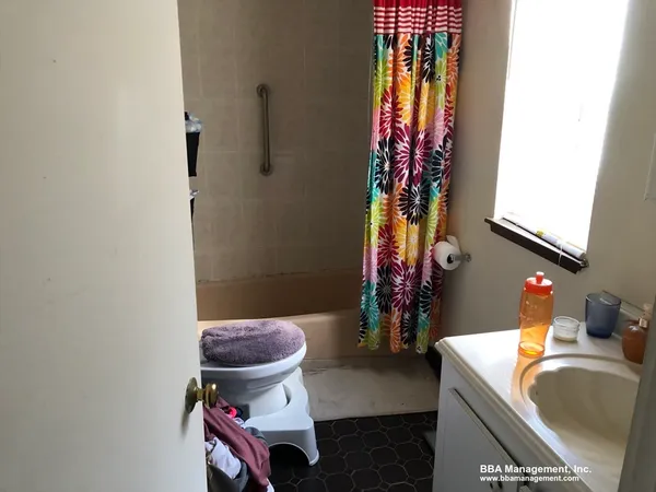 a bathroom with a sink toilet and a mirror