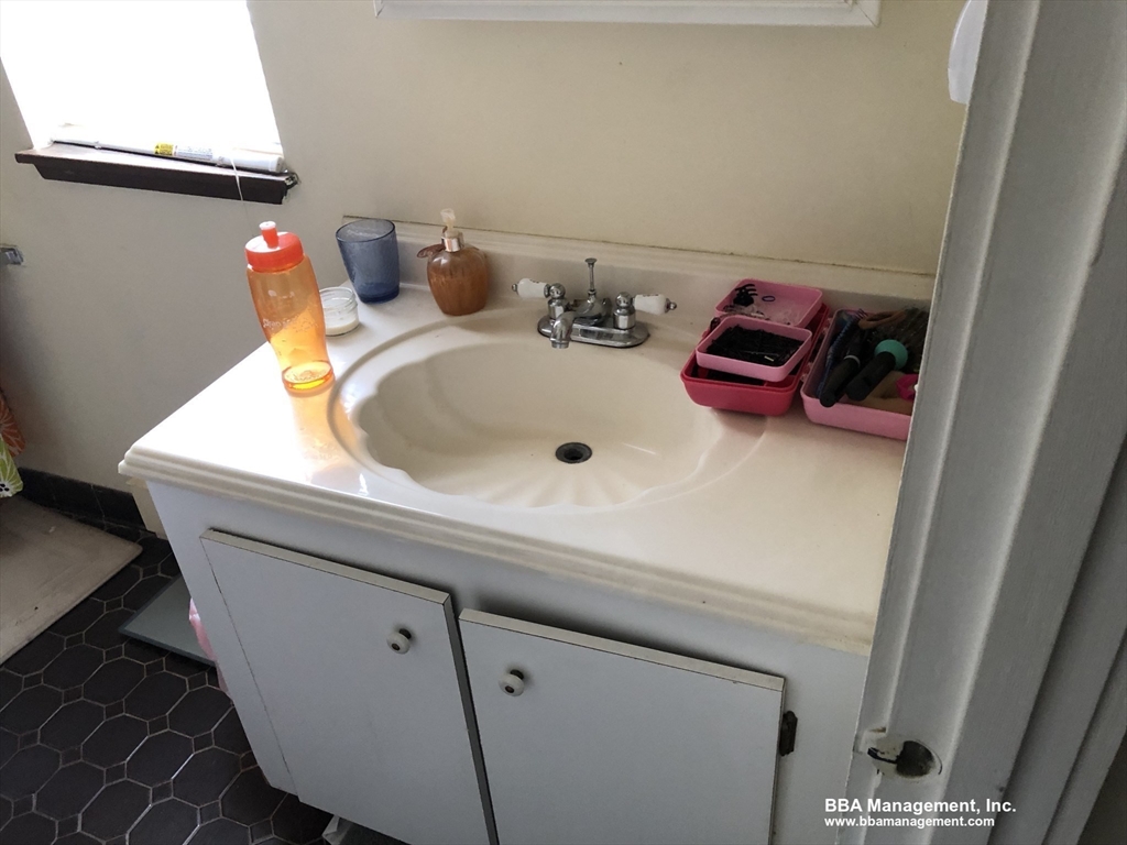 4 Cypress Road, Unit 406 Boston, MA 02135 - Photo 19 of 31 a bathroom with a sink and a mirror