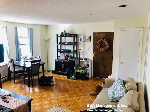 a living room with furniture and a dining table