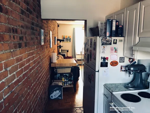 a kitchen with refrigerator and cabinets