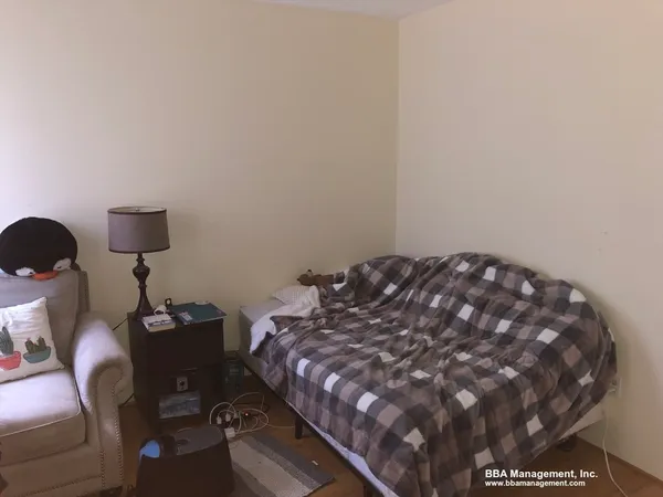 a bed sitting in a bedroom next to a lamp