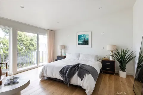 a bedroom with bed and a large window