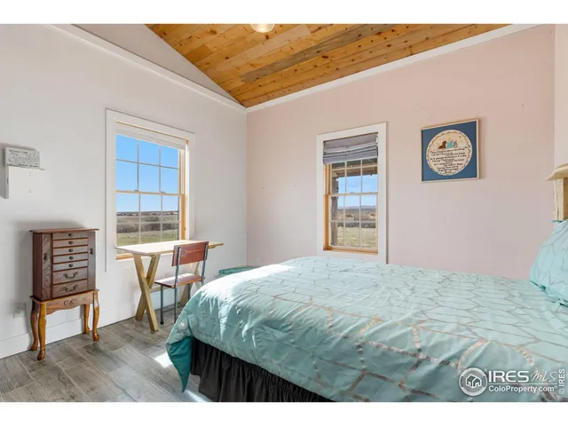 a bathroom with a granite countertop sink a toilet a mirror and shower