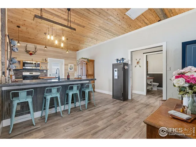a open kitchen with stainless steel appliances granite countertop a stove and a refrigerator