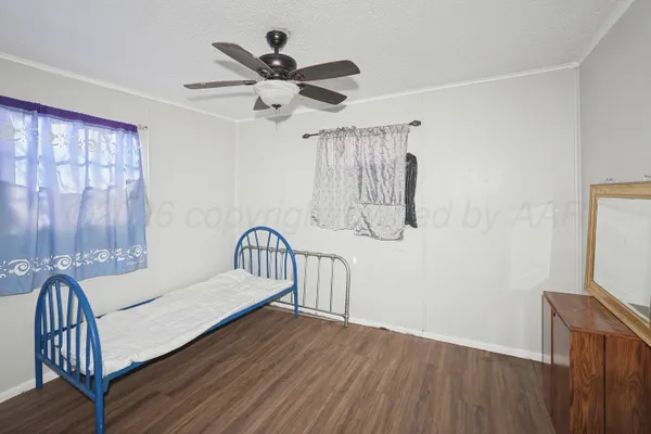 a bedroom with furniture and wooden floor