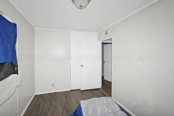 a view of room with window and wooden floor