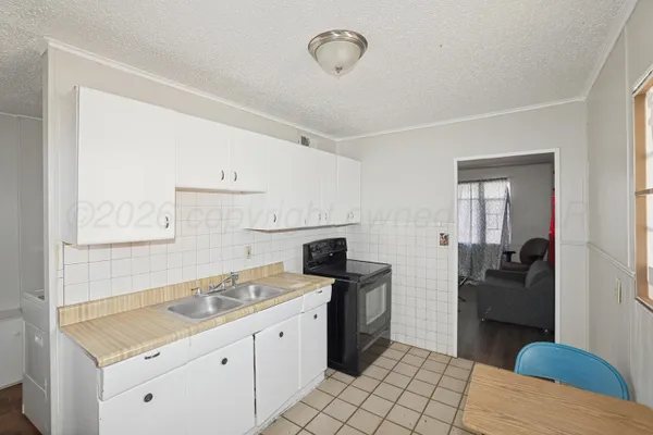 a kitchen with a sink stove and cabinets