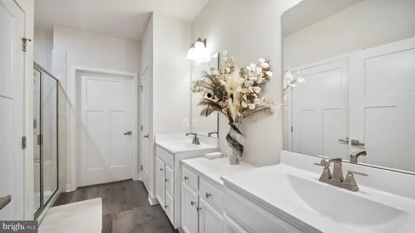 a bathroom with a double vanity sink and a mirror