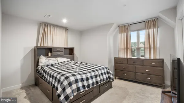 a bedroom with a bed and window