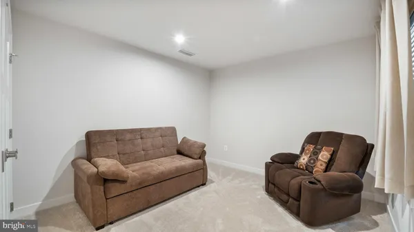 a living room with furniture a couch and a couch