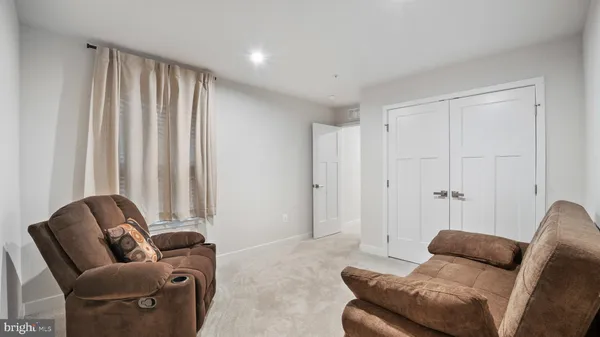 a living room with furniture and a rug
