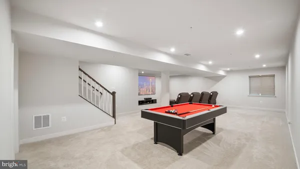 a living room with pool table and furniture