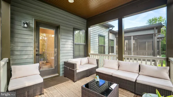 a outdoor living space with patio furniture and a large window