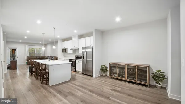a view of kitchen with stainless steel appliances kitchen island sink stove and refrigerator