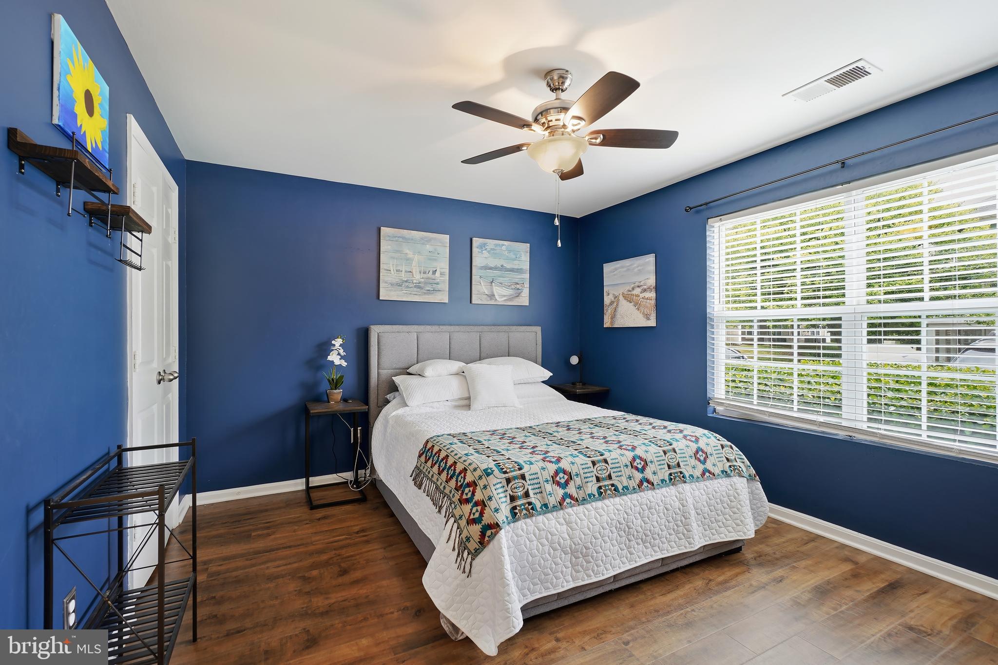 14151 Cuddy Loop, Unit 101 Woodbridge, VA 22193 - Photo 12 of 45 a bedroom with a large bed and a chandelier
