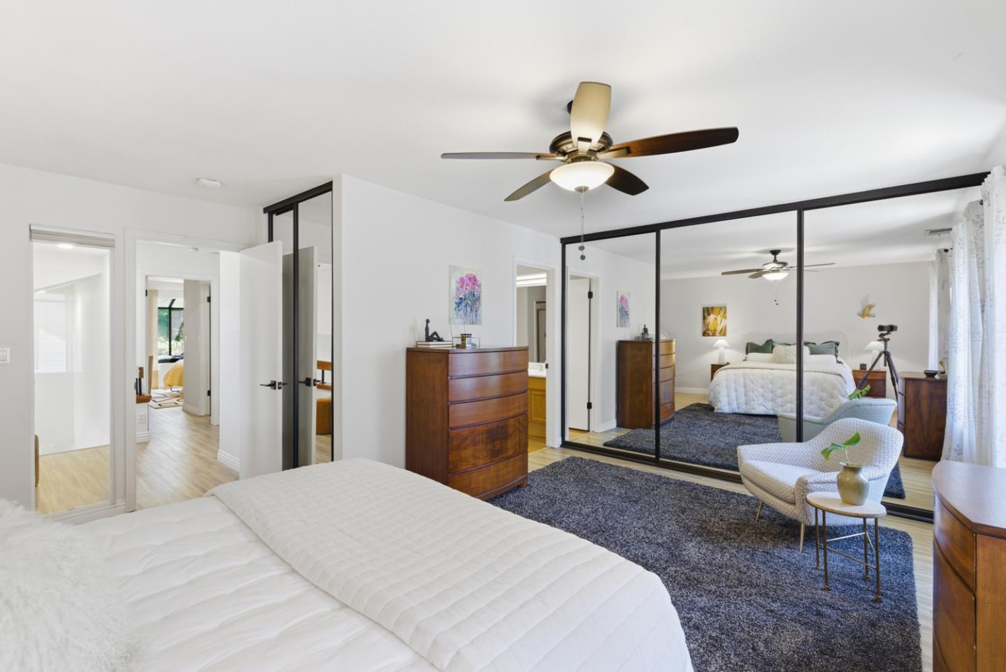 1669 Geary Road Walnut Creek, CA 94597 - Photo 30 of 39 a bedroom with a bed a chandelier and flat screen tv