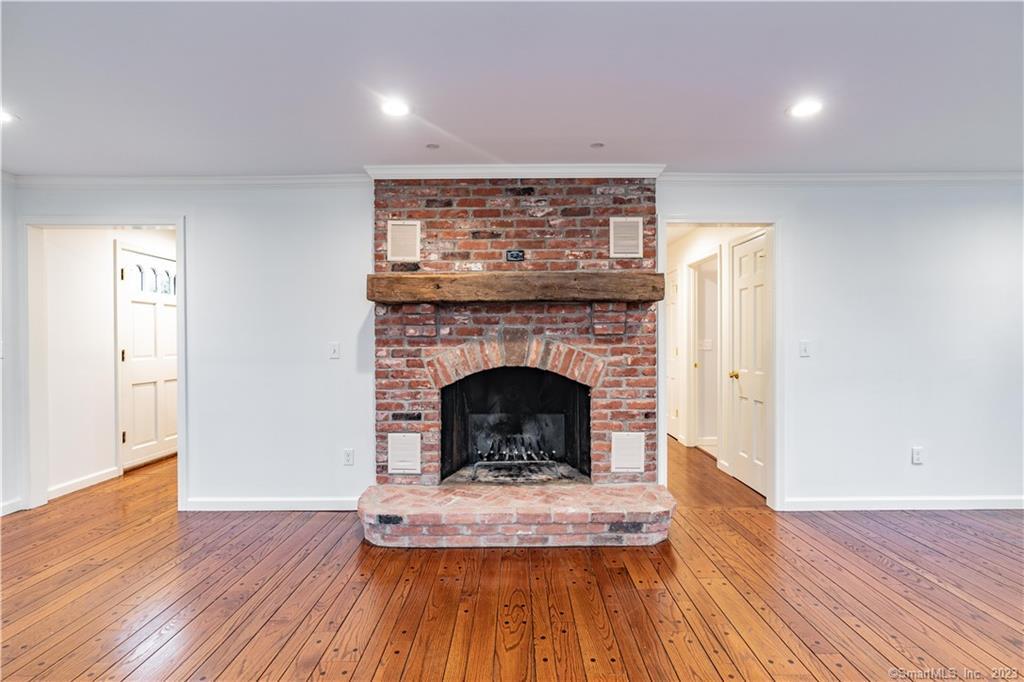 1241 Halladay Avenue West Suffield, CT 06078 - Photo 13 of 29 a living room with a fireplace and wooden floor