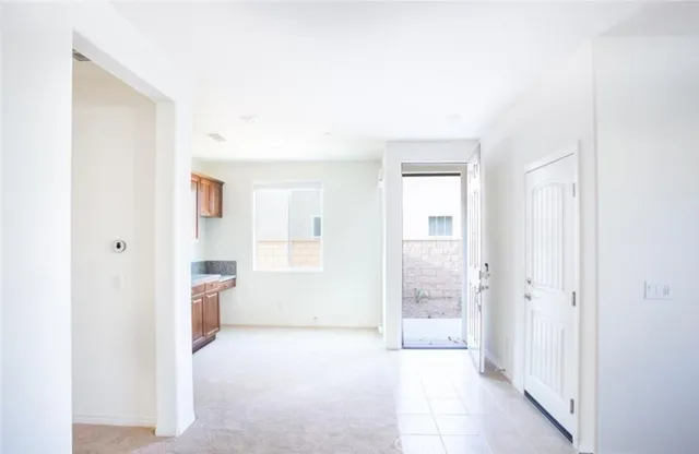 a room with stainless steel appliances wooden cabinets and a window