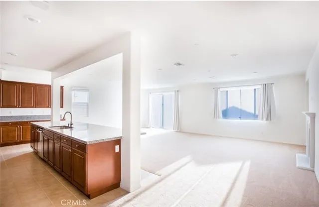 a spacious bathroom with a granite countertop sink a mirror and bathtub
