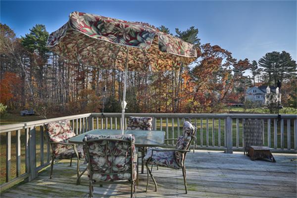 161 Timber Swamp Road Hampton, NH 03842 - Photo 13 of 16 a view of a chairs and table on the deck