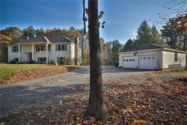 161 Timber Swamp Road Hampton, NH 03842 - Photo 2 of 16 a front view of a house with a garden