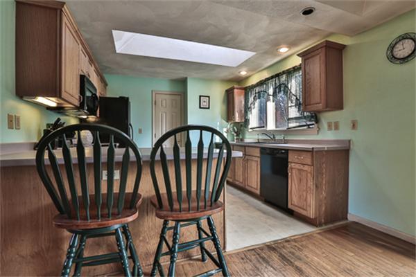 161 Timber Swamp Road Hampton, NH 03842 - Photo 7 of 16 a view of a kitchen with furniture and wooden floor