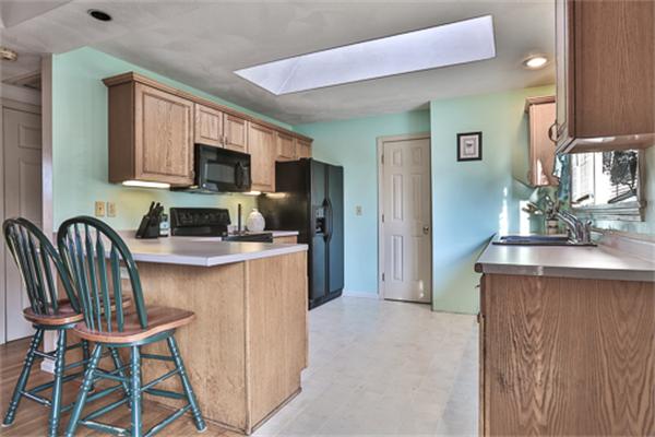 161 Timber Swamp Road Hampton, NH 03842 - Photo 8 of 16 a kitchen with stainless steel appliances a microwave a sink and a refrigerator
