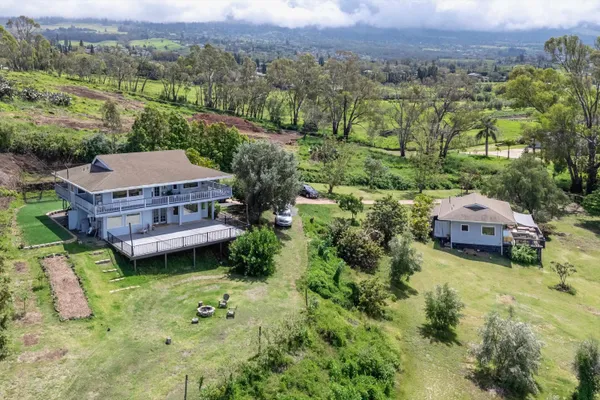 an aerial view of a house with a garden and a swimming pool