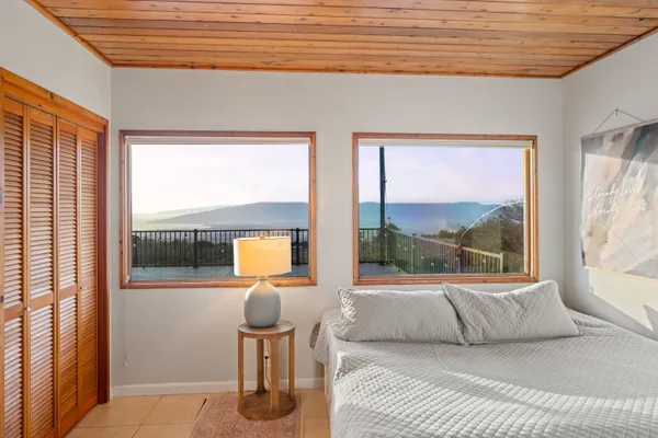 a bedroom with furniture and a large window