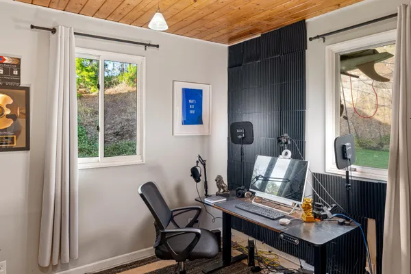 a view of a workspace with furniture and a window