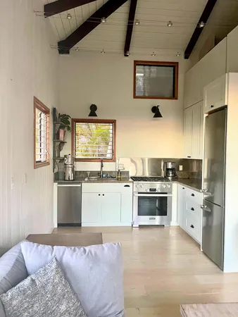 a living room with furniture and floor to ceiling windows